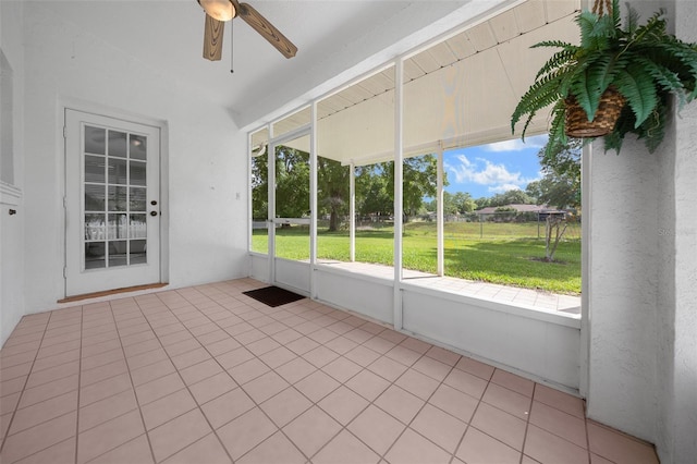 unfurnished sunroom featuring ceiling fan