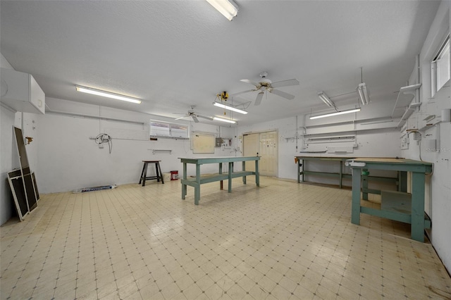 rec room featuring a workshop area, a ceiling fan, and tile patterned floors