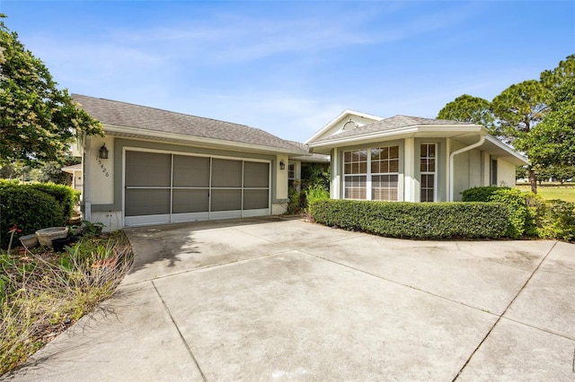 15426 SW 14th Avenue Rd, Ocala, FL 34473 - ranch-style house featuring an attached garage, concrete driveway, and stucco siding