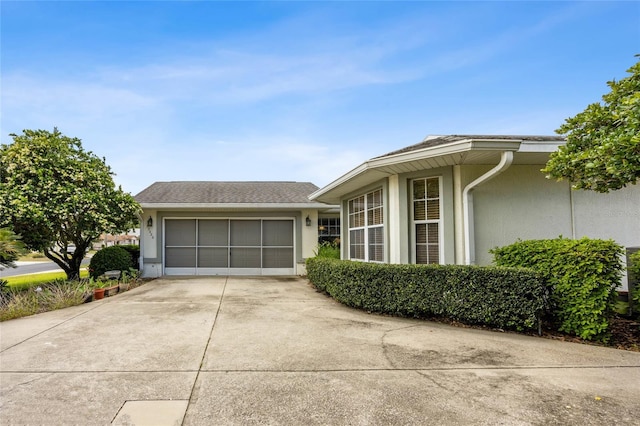 15426 SW 14th Avenue Rd, Ocala, FL 34473 - view of front of home with a shingled roof, driveway, stucco siding, and an attached garage