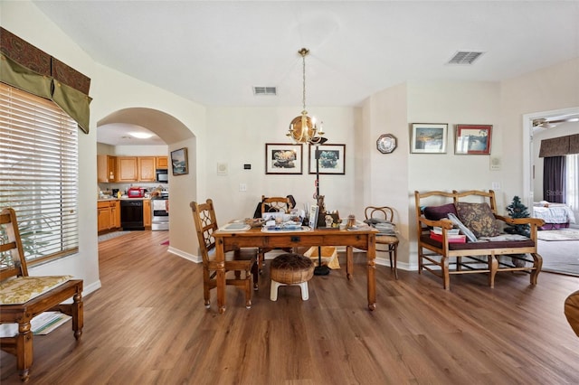 15426 SW 14th Avenue Rd, Ocala, FL 34473 - dining room with visible vents, arched walkways, and wood finished floors