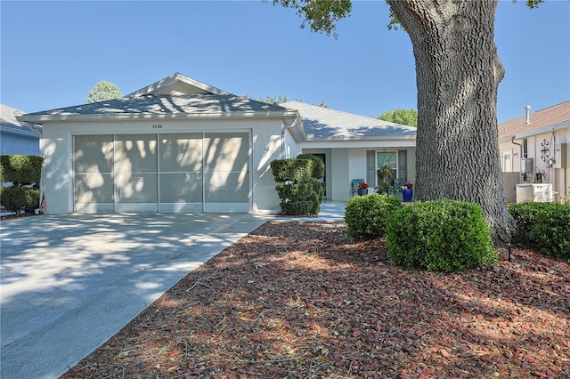 ranch-style house with driveway, a garage, and stucco siding