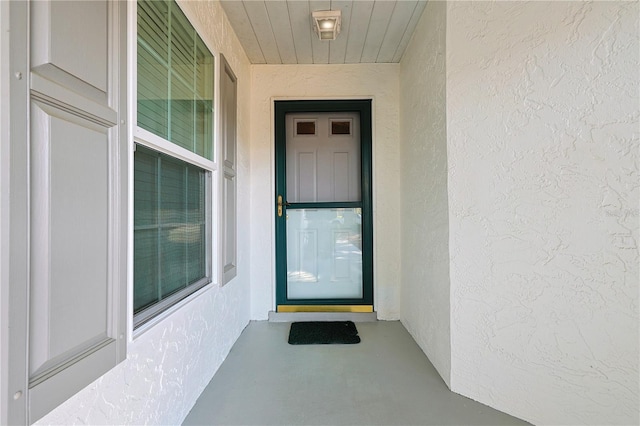 entrance to property featuring stucco siding