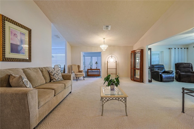 carpeted living area featuring an inviting chandelier, visible vents, a textured ceiling, and baseboards