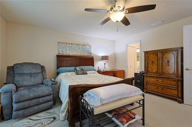 bedroom featuring visible vents, a ceiling fan, carpet, and a textured ceiling