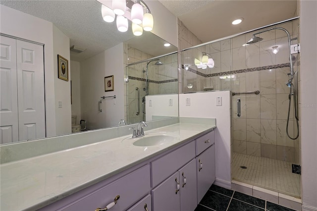 full bathroom featuring tile patterned floors, vanity, visible vents, and a stall shower