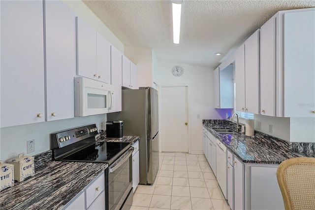 kitchen with white cabinetry, marble finish floor, a sink, and white appliances