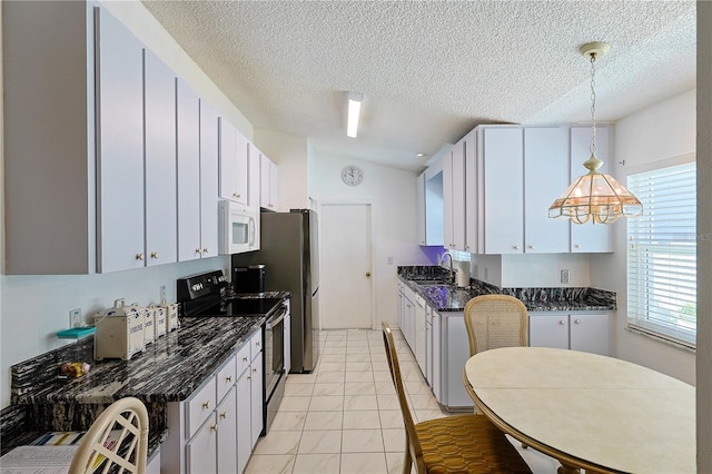 kitchen featuring a sink, a textured ceiling, white microwave, pendant lighting, and electric range
