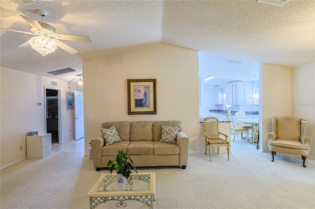 living room featuring baseboards, vaulted ceiling, light carpet, a textured ceiling, and a ceiling fan