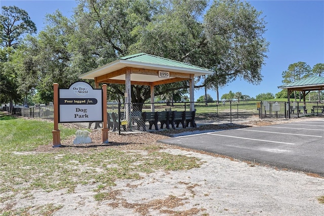 surrounding community featuring a gazebo, fence, and uncovered parking