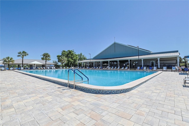 pool with fence and a patio