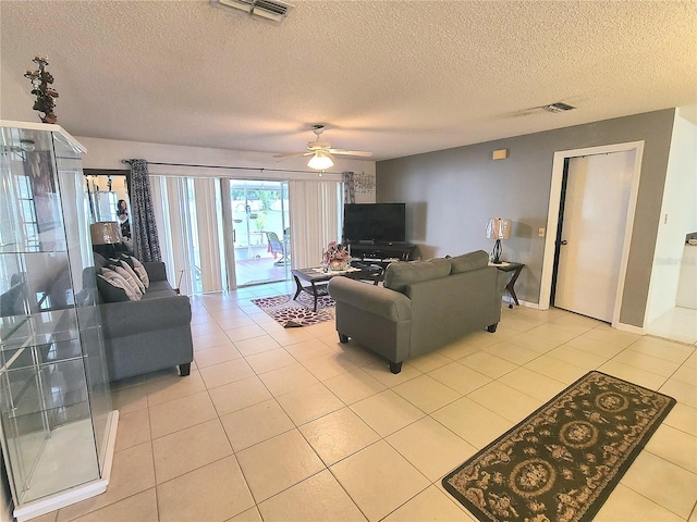 5606 SW 107th St, Ocala, FL 34476 - living room featuring a textured ceiling, light tile patterned floors, a ceiling fan, and visible vents