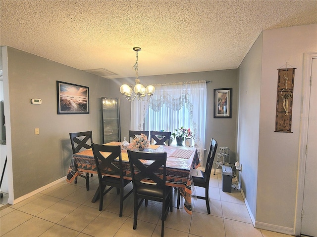 5606 SW 107th St, Ocala, FL 34476 - dining area with light tile patterned floors, baseboards, an inviting chandelier, and a textured ceiling