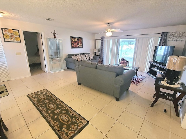 5606 SW 107th St, Ocala, FL 34476 - living room with light tile patterned floors, visible vents, a textured ceiling, and a ceiling fan
