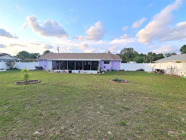 5606 SW 107th St, Ocala, FL 34476 - back of property featuring a sunroom, a yard, and a fenced backyard