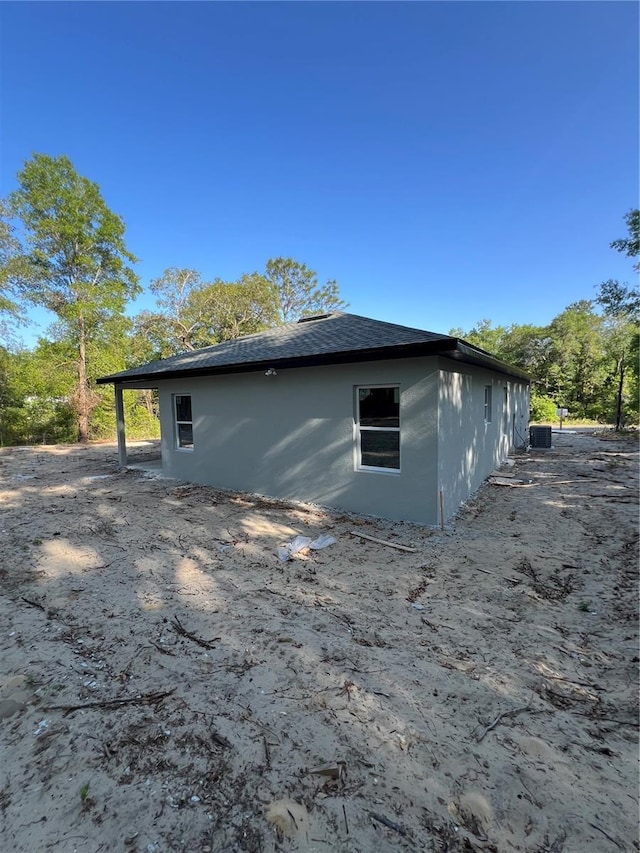 1581 W Saint Elizabeth Pl, Citrus Springs, FL 34434 - view of side of home with central AC and stucco siding