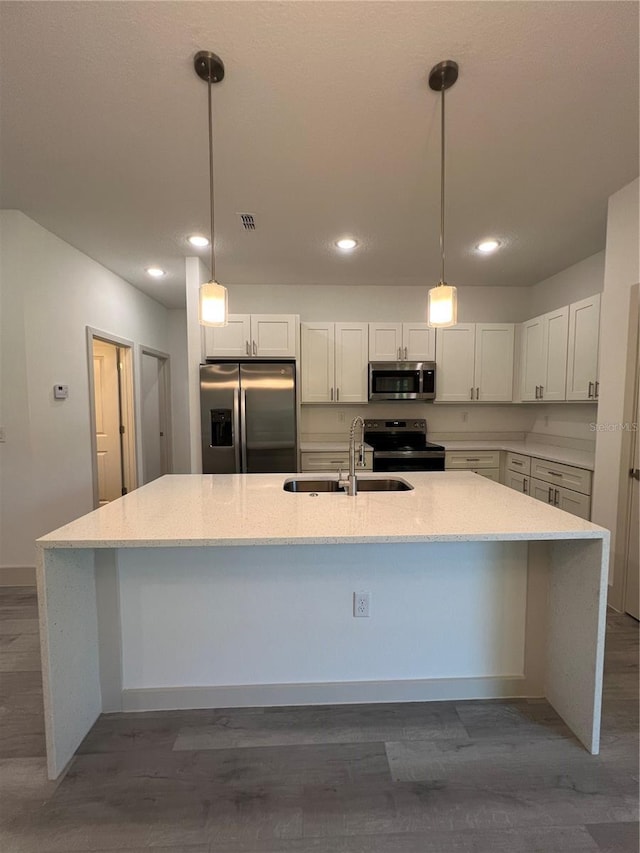 1581 W Saint Elizabeth Pl, Citrus Springs, FL 34434 - kitchen featuring recessed lighting, light stone countertops, a sink, a spacious island, and appliances with stainless steel finishes