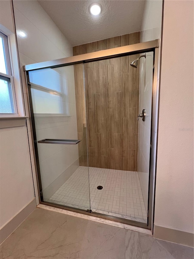 1581 W Saint Elizabeth Pl, Citrus Springs, FL 34434 - bathroom with baseboards, a shower stall, and a textured ceiling
