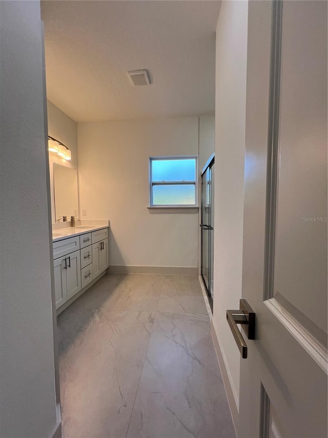 1581 W Saint Elizabeth Pl, Citrus Springs, FL 34434 - full bath with baseboards, a shower stall, vanity, and marble finish floor
