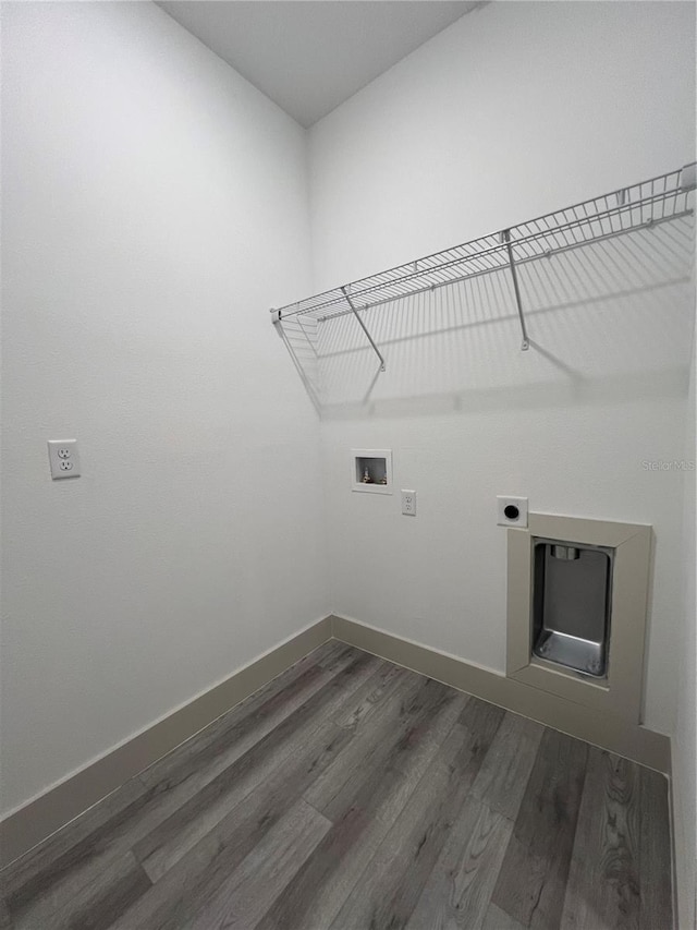 1581 W Saint Elizabeth Pl, Citrus Springs, FL 34434 - clothes washing area with hookup for an electric dryer, washer hookup, baseboards, dark wood finished floors, and laundry area