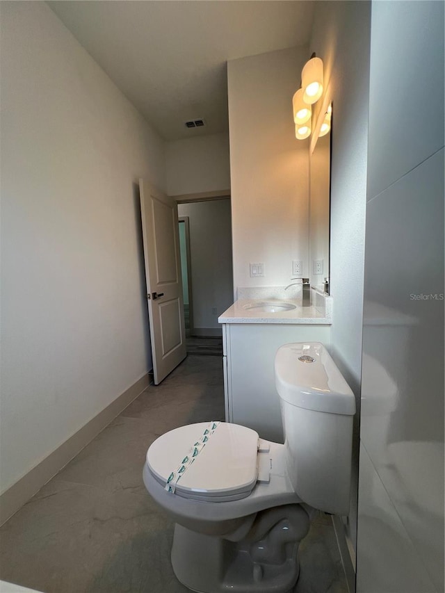 1581 W Saint Elizabeth Pl, Citrus Springs, FL 34434 - bathroom with baseboards, visible vents, toilet, and vanity