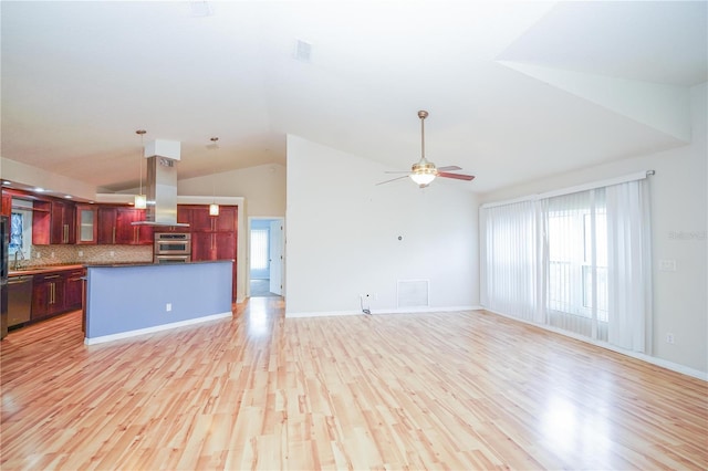 unfurnished living room featuring light wood-style flooring, a sink, ceiling fan, baseboards, and high vaulted ceiling