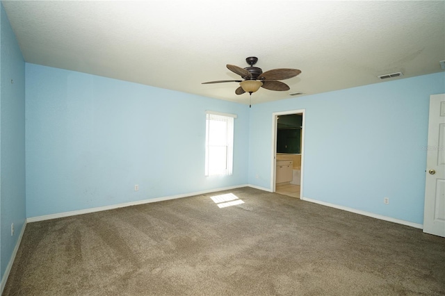 unfurnished bedroom featuring a ceiling fan, visible vents, light colored carpet, and baseboards