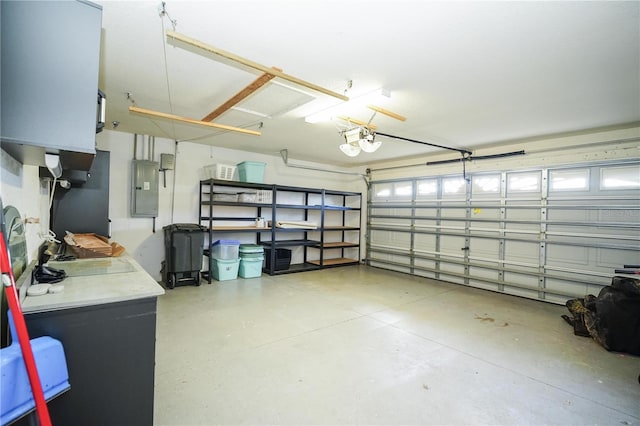 garage with electric panel and a garage door opener