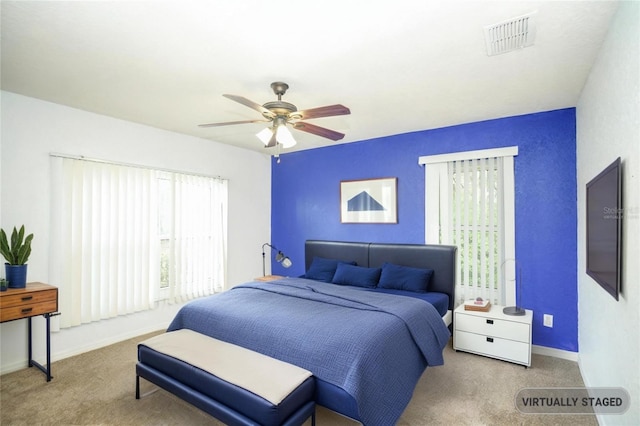 carpeted bedroom featuring visible vents, ceiling fan, and baseboards