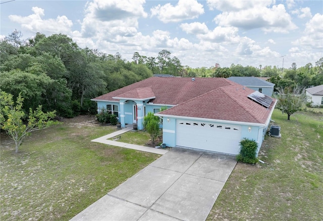 2730 SW 162nd Street Rd, Ocala, FL 34473 - mediterranean / spanish home with a garage, stucco siding, a front yard, driveway, and roof mounted solar panels