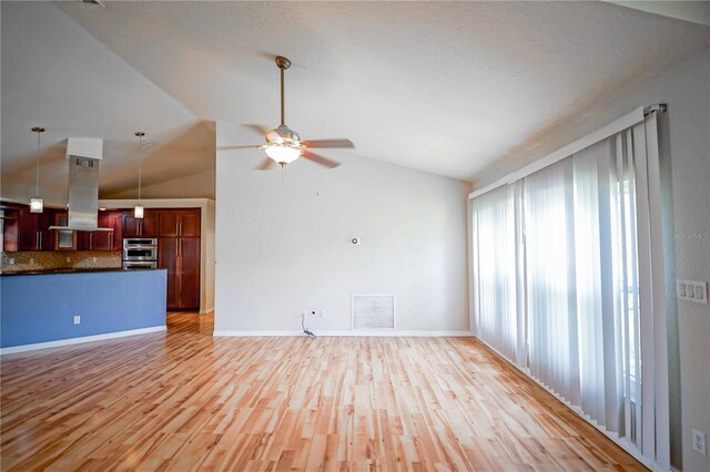 2730 SW 162nd Street Rd, Ocala, FL 34473 - unfurnished living room with vaulted ceiling, a ceiling fan, and light wood-style floors