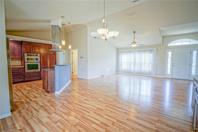 2730 SW 162nd Street Rd, Ocala, FL 34473 - kitchen with high vaulted ceiling, island exhaust hood, open floor plan, light wood-type flooring, and ceiling fan