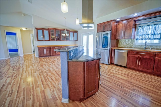 2730 SW 162nd Street Rd, Ocala, FL 34473 - kitchen featuring appliances with stainless steel finishes, light wood-style flooring, vaulted ceiling, a kitchen island, and glass insert cabinets