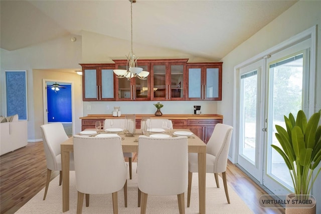 2730 SW 162nd Street Rd, Ocala, FL 34473 - dining area featuring vaulted ceiling, light wood finished floors, and a chandelier
