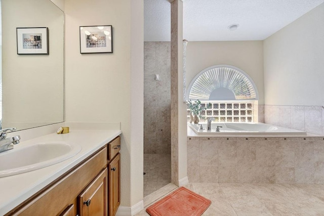 bathroom with a bath, walk in shower, vanity, and tile patterned flooring