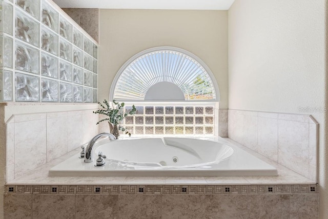 bathroom featuring a tub with jets