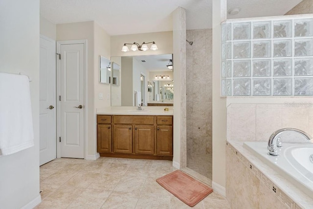 full bath with tile patterned floors, baseboards, walk in shower, a garden tub, and vanity