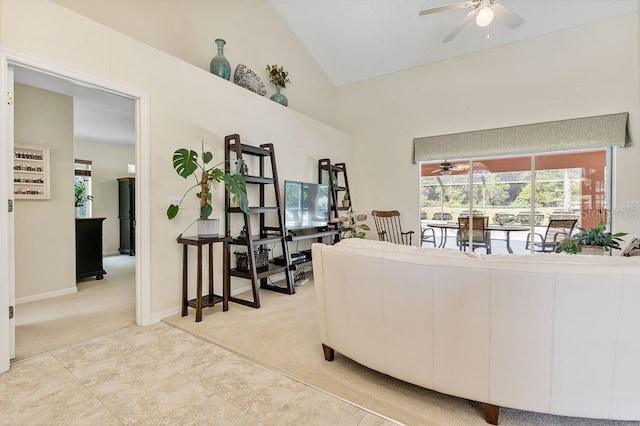 living area with light carpet, a ceiling fan, baseboards, and high vaulted ceiling