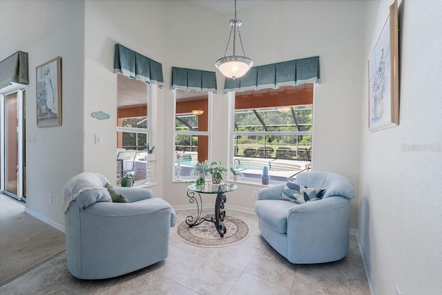 living area with tile patterned floors and baseboards