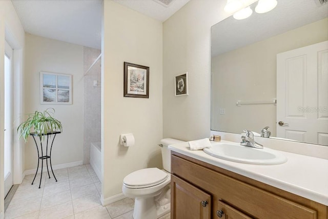 full bath featuring washtub / shower combination, tile patterned floors, toilet, vanity, and baseboards
