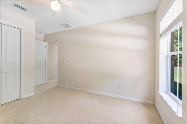 unfurnished bedroom with light carpet, baseboards, and visible vents
