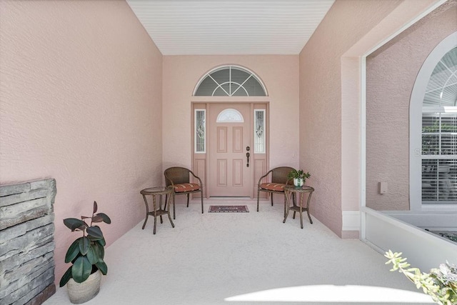 property entrance with stucco siding