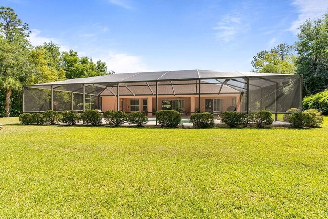 rear view of property featuring a yard