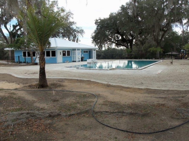 view of swimming pool with a fenced in pool, a patio, and fence