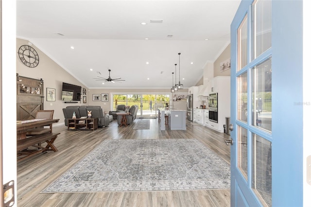 9950 NW 11th Ter, Ocala, FL 34475 - living area with lofted ceiling, light wood-style flooring, crown molding, and a ceiling fan