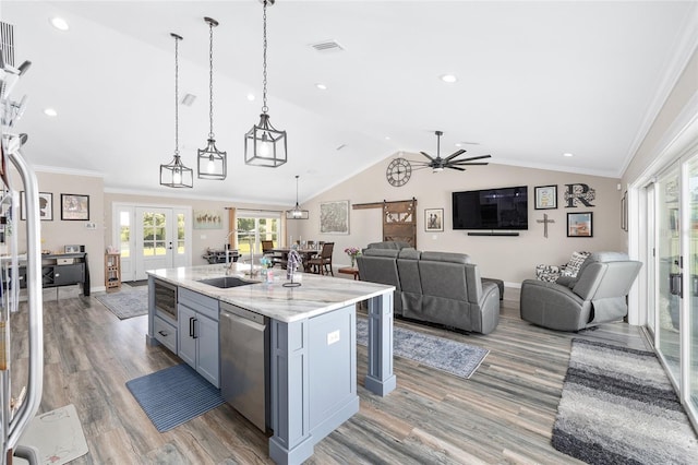 9950 NW 11th Ter, Ocala, FL 34475 - kitchen with stainless steel dishwasher, open floor plan, light wood-style flooring, a ceiling fan, and lofted ceiling