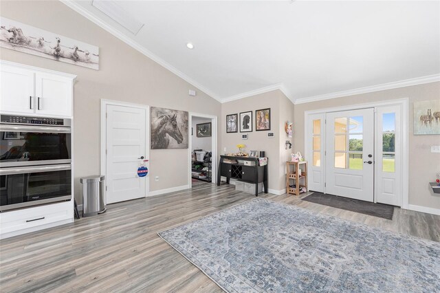 9950 NW 11th Ter, Ocala, FL 34475 - entryway with light wood finished floors, lofted ceiling, and ornamental molding