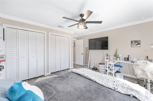 9950 NW 11th Ter, Ocala, FL 34475 - bedroom with two closets, ornamental molding, wood finished floors, and a ceiling fan