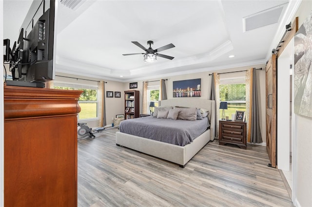 9950 NW 11th Ter, Ocala, FL 34475 - bedroom featuring a tray ceiling, multiple windows, light wood-style floors, ornamental molding, and recessed lighting