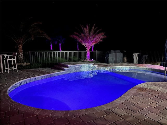 9950 NW 11th Ter, Ocala, FL 34475 - pool at night featuring a patio